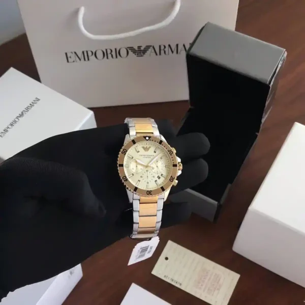 ساعة امبريو ارماني استيك معدن – فخامة فضي × ذهبي بإطلالة راقية